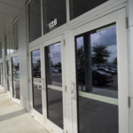 Commercial glass doors at Oratso Corporation's Regal Project location, showcasing modern design and accessibility for door and window solutions.