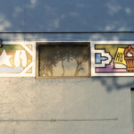 Mural depicting cultural symbols and artistic elements on a building wall, relevant to Oratso Corp's focus on cultural art centers.