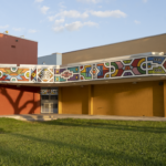 Cultural art center exterior featuring colorful mural and grassy area, representing Oratso Corp's community-focused services in South Florida and Caribbean Islands.