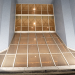 Interior view of a grand apartment showcasing large glass windows and modern architectural design, emphasizing light and space, relevant to Oratso Corporation's apartment offerings.