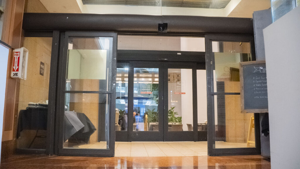 Automatic sliding glass doors at an apartment entrance, showcasing modern design and accessibility features, relevant to Oratso Corporation's offerings in Miami.