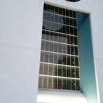 Modern apartment building facade with large windows and geometric design, showcasing Oratso Corporation's architectural style in Miami.